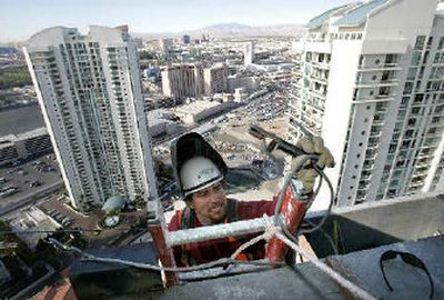 
William Rivas welds panel clips at Turnberry Place in Las Vegas.  
 (Associated Press / The Spokesman-Review)