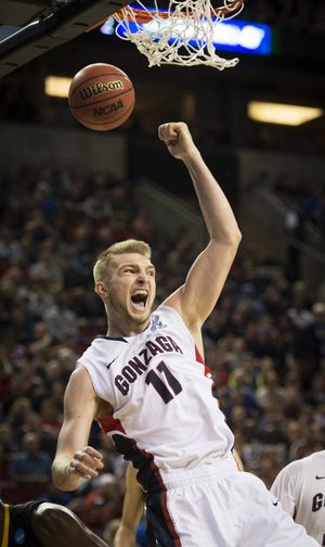 Gonzaga forward Domantas Sabonis (11) slam dunks the ball in the first half of a third round NCAA men's tournament basketball game, Sunday, March, 22, 2015, at KeyArena in Seattle. (The Spokesman-Review)