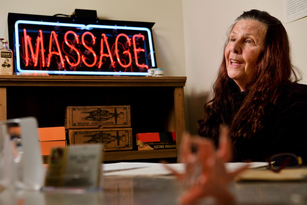 Judi Calvert smiles as she talks about her massage memorabilia collection on Oct. 2 in Spokane. (Tyler Tjomsland / The Spokesman-Review)