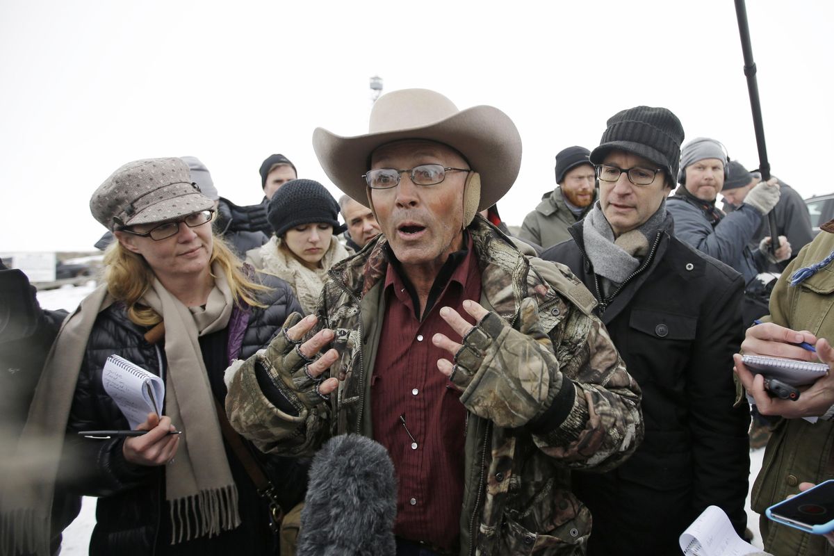 LaVoy Finicum, center, a rancher from Arizona, talks to reporters Jan. 5, 2016 at the Malheur National Wildlife Refuge near Burns, Ore. (Rick Bowmer / Associated Press)