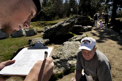 “This is just the first step to privatizing this hill,” said Coeur d’Alene attorney Steve Bell, right, as Ryan Ghramm, left, of Hayden, signed a petition on Tuesday asking the Coeur d’Alene City Council not to allow commercial  tours of Tubbs Hill.  (Kathy Plonka / The Spokesman-Review)