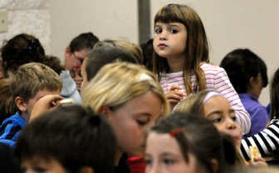 
Atlas Elementary School fourth-grader Katharina Dilsaver  peers over the crowd during lunch at the school in Hayden on Wednesday.  
 (Kathy Plonka / The Spokesman-Review)