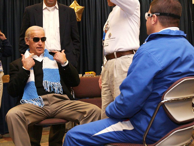 ORG XMIT: IDMC105 Vice President Joe Biden points to some new sunglasses he tried on while talking with Special Olympics athlete Michael Barrantes on Thursday, Feb. 12, 2009 in Boise, Idaho. Biden talked with Barrantes, a floor hockey medalist from Costa Rica, in one of the Special Olympics venues that focuses on the health of the athletes. This program is called Opening Eyes and it provides eye check ups with immediate glasses, sunglasses and sports glasses presented to the athletes free of charge. (AP Photo/Matt Cilley) (Matt Cilley / The Spokesman-Review)