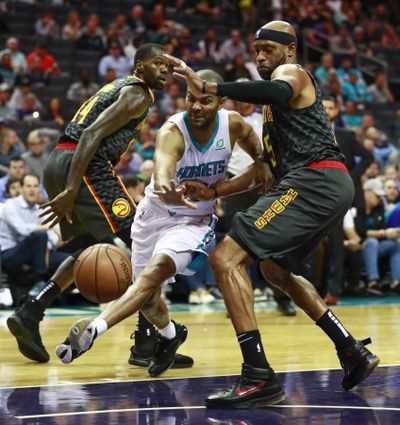 Charlotte Hornets guard Tony Parker, center, tries to get past Atlanta Hawks guard Vince Carter on Tuesday night in Charlotte, N.C. (Jason E. Miczek / Associated Press)