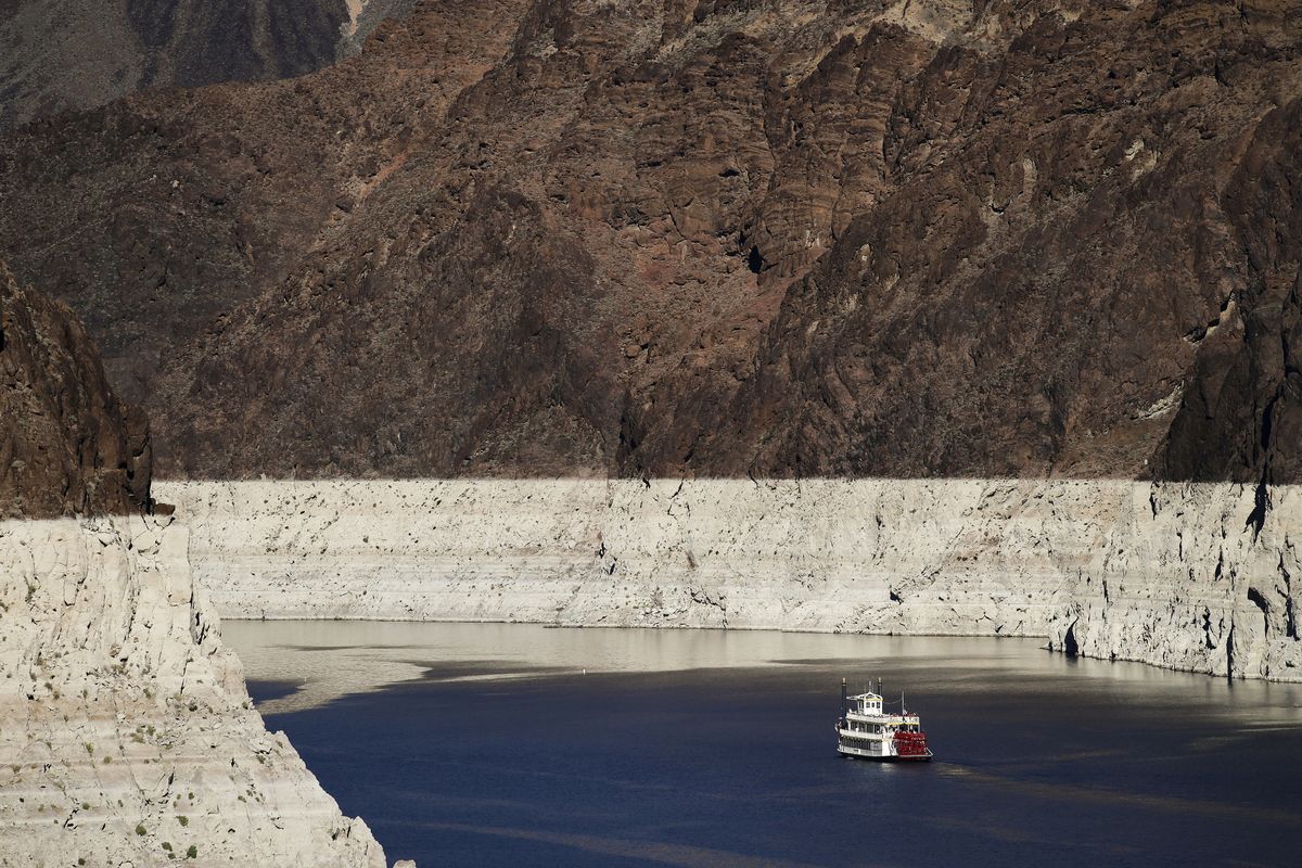 FILE - In this Oct. 14, 2015, file photo, a riverboat glides through Lake Mead on the Colorado River at Hoover Dam near Boulder City, Nev. The key reservoir on the Colorado River is expected to match its record low level on Thursday, June 10, 2021. The dropping surface elevation of Lake Mead along the Arizona-Nevada border is the another sign of the drought