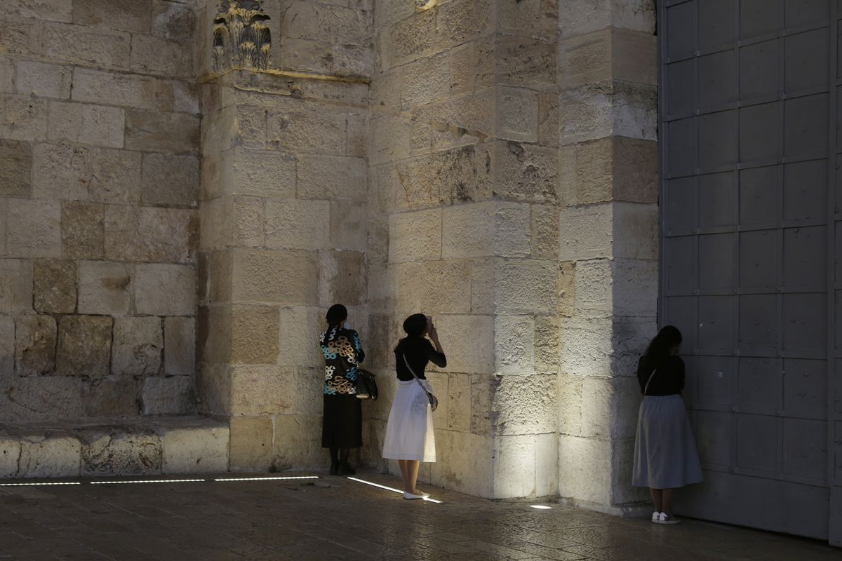 Jewish women pray at the Jaffa Gate to the Old City of Jerusalem, after they were turned away by police on their way to pray at the Western Wall, during a nationwide three-week lockdown to curb the spread of the coronavirus, Tuesday, Sept. 22, 2020,.  (Maya Alleruzzo)
