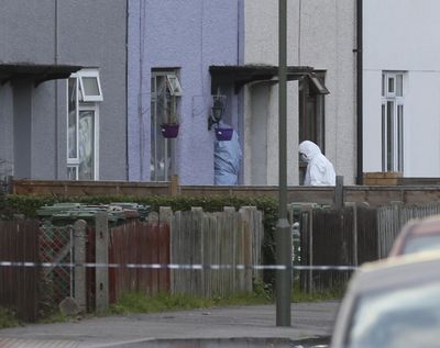 Police forensic officers enter a property in Sunbury-on-Thames, southwest London, as part of the investigation into Friday’s Parsons Green bombing, Saturday Sept, 16, 2017. (Jonathan Brady / Associated Press)