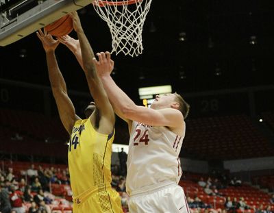 Cal forward Christian Behrens grabs a rebound in front of WSU forward Josh Hawkinson during the first half. (Associated Press)