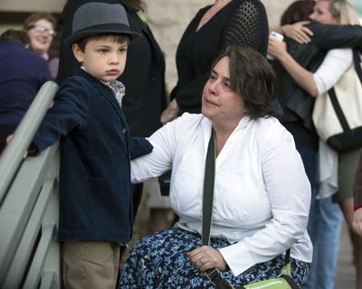 Shelia Robertson, an original plaintiff in the gay marriage case against Idaho, tells her son, Bridger, that she was denied a marriage license outside the Ada County Courthouse in Boise on Wednesday. (Associated Press)