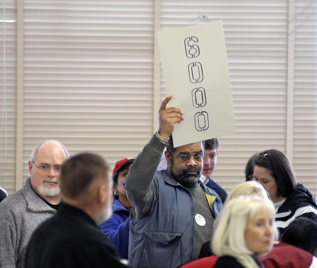 Jeff Johnston holds up a precinct sign as he attends the Democratic caucus sessions at Salk Middle School in Spokane on February 9, 2008. (Christopher Anderson / The Spokesman-Review)