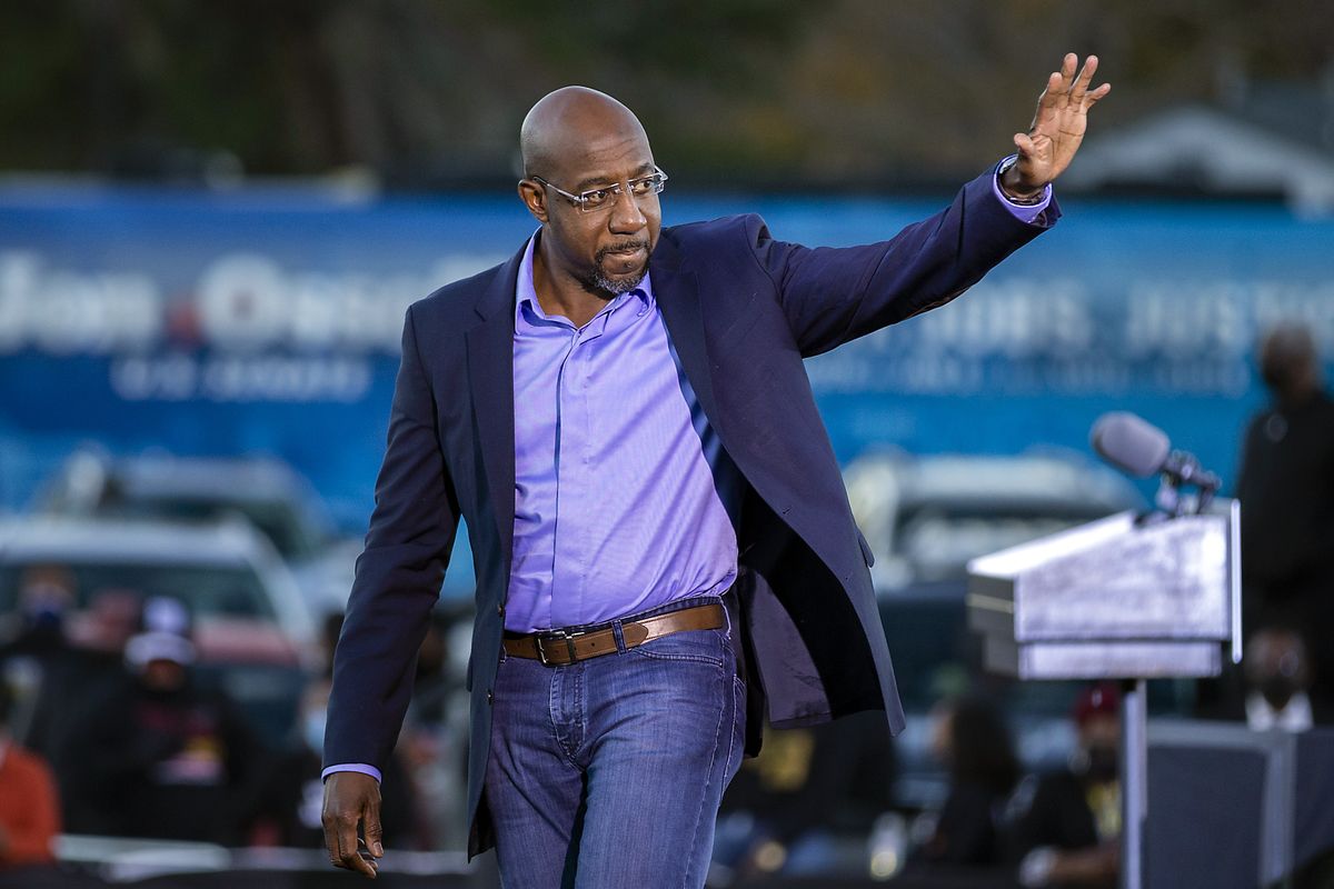 Democratic U.S. Senate candidate Rev. Raphael Warnock waves to supporters during a drive-in rally, Sunday, Jan. 3, 2021, in Savannah, Ga. Vice President-elect Kamala Harris made a campaign stop for Georgia candidates Warnock and Jon Ossoff before the runoff election Tuesday. (Stephen B. Morton)