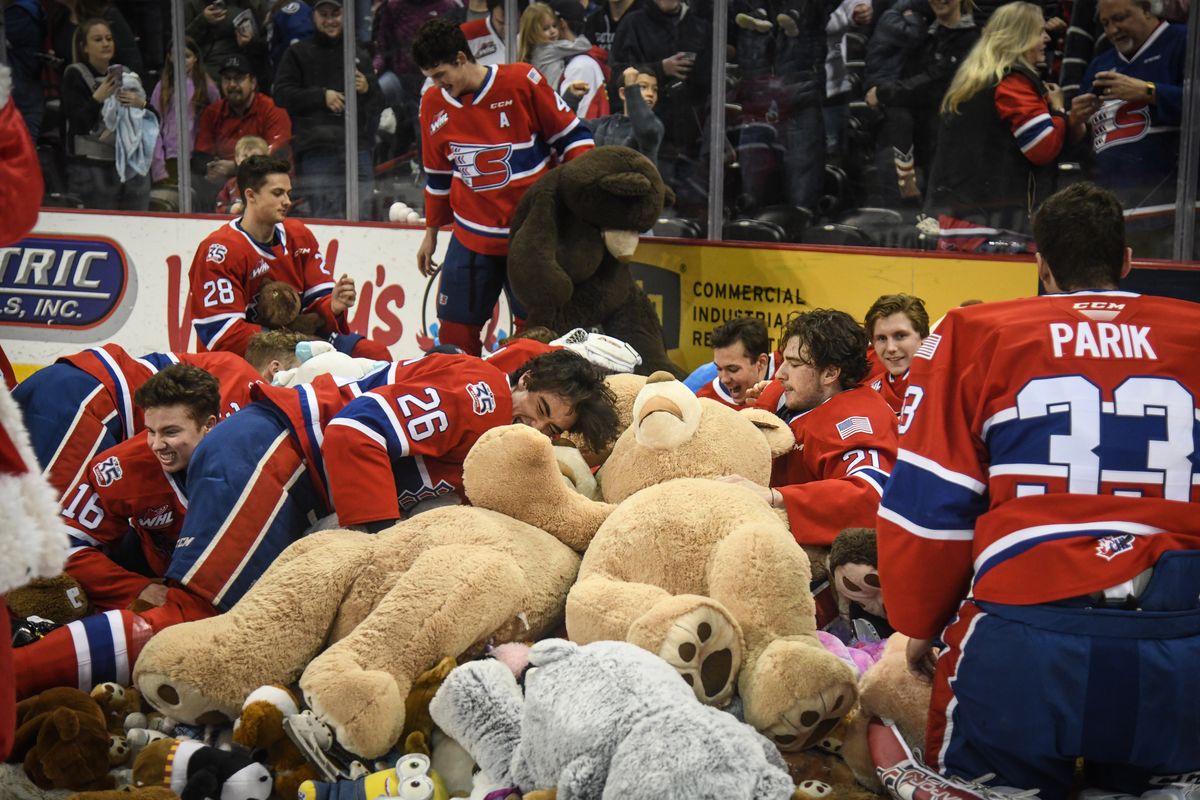 Spokane Chiefs players dog-pile into stuffed animals on Teddy Bear Toss night in this photo from 2019. The popular hockey game and toss are Saturday, Dec. 4.  (DAN PELLE)