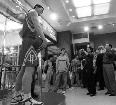 
A crowd looks at a wax figure of Yao Ming in Shanghai. 
 (Associated Press / The Spokesman-Review)