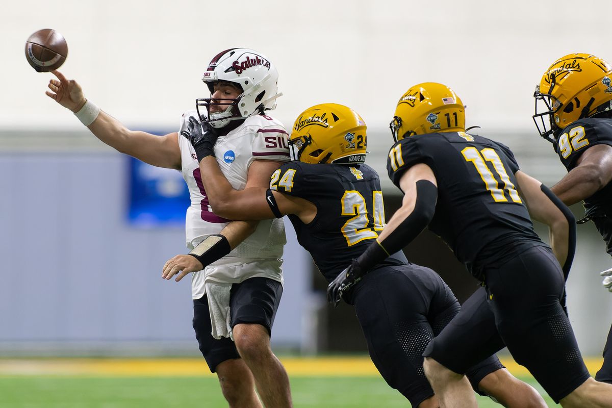 Southern Illinois quarterback Nic Baker throws under pressure from Idaho