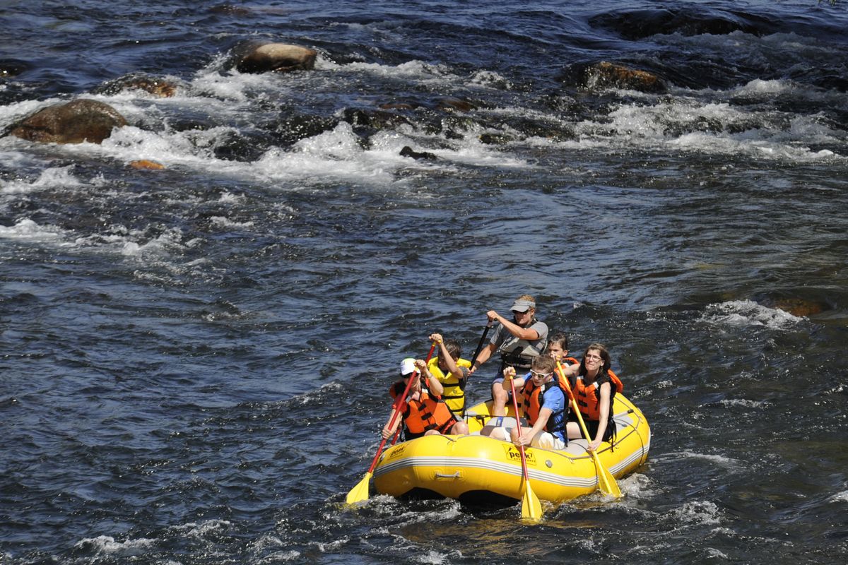 Rafters led by guide Nicole Winters, top, negotiate some riffles near the Sandifur Bridge west of downtown Saturday. Peak7, a nonprofit, offered the free float trip during the Spokane River Festival, a gathering of organizations interested in recreation on the river. (Jesse Tinsley)