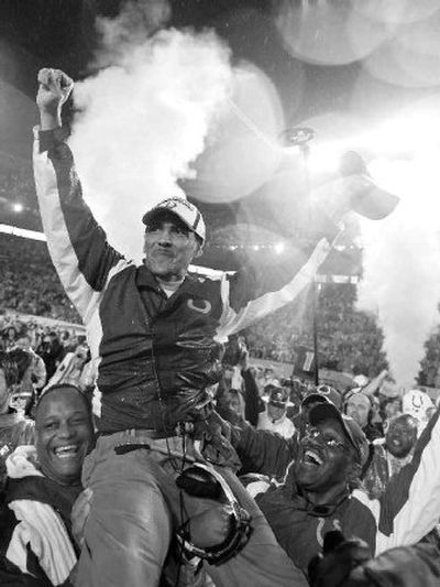 
Indianapolis coach Tony Dungy hitches a ride through the crowd after the Colts defeated the Bears. 
 (Associated Press / The Spokesman-Review)