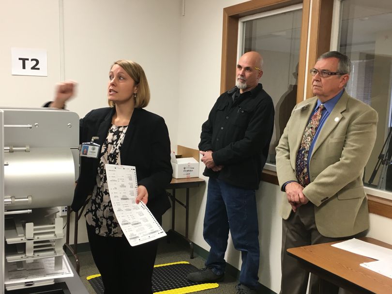 Kootenai County Elections Manager Carrie Phillips scans test ballots Monday to verify the operation of the county's two high-speed scanner and tabulator machines at the elections office. County Clerk Jim Brannon, right, and Bob Bingham, a candidate for county commissioner representing District 3, observe the logic and accuracy test.  (Scott Maben)