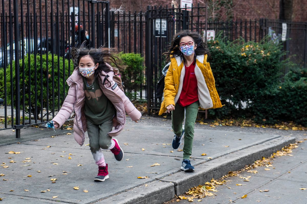 FILE — Students wearing masks leave the New Explorations into Science, Technology and Math (NEST+m) school in the Lower East Side neighborhood of Manhattan, Dec. 21, 2021, in New York. The New York State Education Department is telling schools to continue to require masks despite a judge’s ruling overturning the state's mask mandate.  But some school districts already are rushing to drop the requirement.  The Education Department said in a statement Tuesday, Jan. 25, 2022 that the state was appealing the ruling, which could temporarily halt it, and that schools should follow the mask rule in the meantime.  (Brittainy Newman)