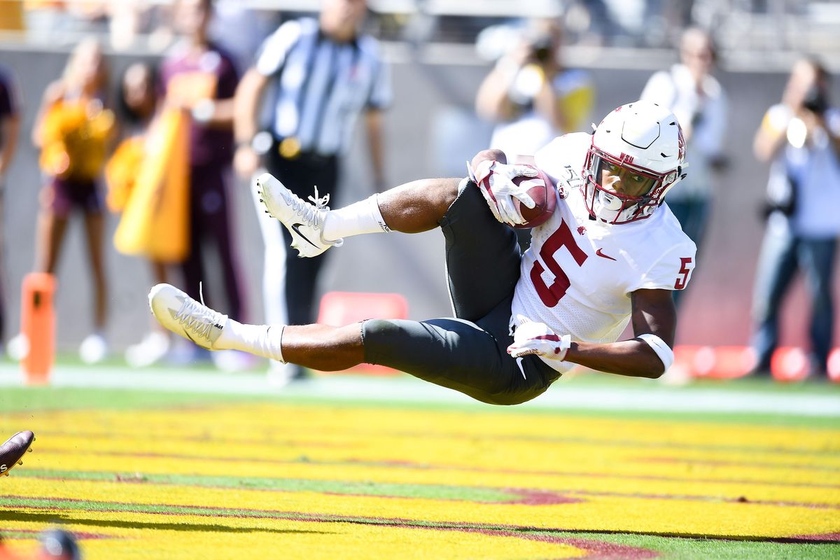 Washington State Cougars wide receiver Travell Harris (5) lands in the end zone with a touchdown catch during the first half of a college football game on Saturday, October 12, 2019, at Sun Devil Stadium in Tempe, Ariz. (Tyler Tjomsland / The Spokesman-Review)