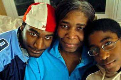 
Elizabeth-Ann Mohammed, 42, is surrounded by two of her children, Nigel Bartholomew, 19, left, and Lukmon Mohammed, 11. Bartholomew recently donated a kidney to his mother. 
 (Baltimore Sun / The Spokesman-Review)