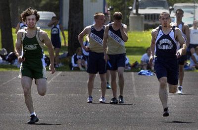 
Ian Boyle of St. Maries, left, and Kyle Behrens of Bonners Ferry, right, duel in the anchor leg of the 400 relay won by St. Maries. Timberlake, center, was leading until a missed baton exchange, but the Tiger boys went on to win the meet. 
 (Jesse Tinsley / The Spokesman-Review)