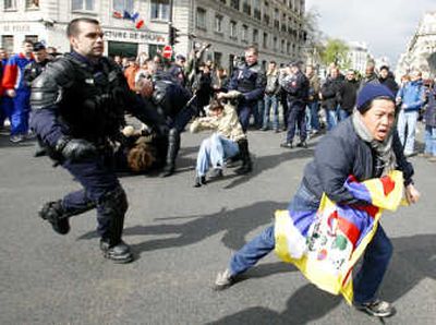 
A pro-Tibet protester flees a police officer during the Olympic torch relay Monday in Paris. Security officials extinguished the torch five times amid  chaotic protests. Associated Press photos
 (Associated Press photos / The Spokesman-Review)
