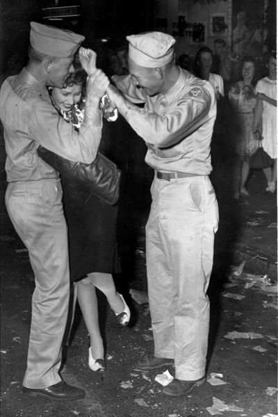 These three revelers were part of the crowd, in downtown Spokane, celebrating the end of the war with Japan.  Word of the war's end touched of celebrations late in the afternoon and into the night.  As many as 50,000 people were estimated to have taken part.   Aug. 14, 1945    (Photo Archive / The Spokesman Review Photo Archi)