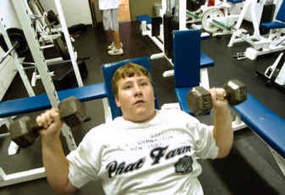 
At the Summer Youth Teen Program at the East Central Community Center, Matthew Buchanan, 15, lifts weights Thursday evening. The city may cut the program because of budget cuts. 
 (Colin Mulvany / The Spokesman-Review)