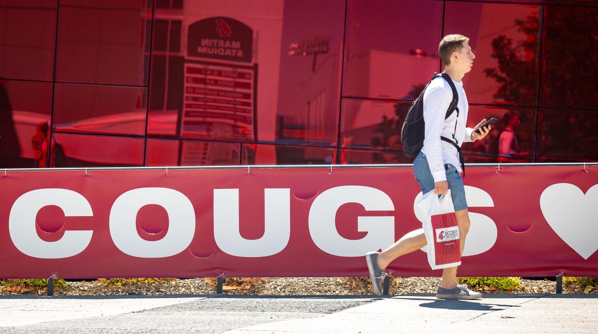 A student walks along the Glenn Terrell Mall on the Washington State University main campus in Pullman, Wash. on the first day of classes for the 2019-2020 year on Monday, Aug. 19, 2019. (Libby Kamrowski / The Spokesman-Review)