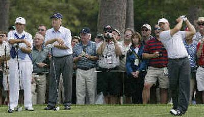
Amateur Ryan Moore, right, tees off from the 15th hole at Augusta National during Wednesday's practice, with Gary Player, left, and Jack Nicklaus, center, watching. 
 (Associated Press / The Spokesman-Review)