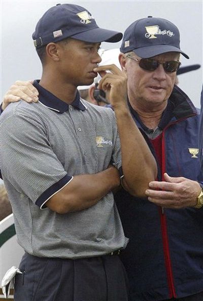 In this Nov. 21, 2003 file photo, United States golf team captain Jack Nicklaus, right, puts his arm around player Tiger Woods before teeing off on the 11th hole during a four-ball match on the second day of the Presidents Cup Golf Tournament at the Fancourt Golf Estate in George, South Africa. Nicklaus believes this is a big year for Woods to get closer to his record 18 major championships because three majors are held on courses where Woods has won. Woods has taken an indefinite leave while he copes with a personal crisis involving extramarital affairs. No one knows when he will return, even with a major rotation that features Augusta National, Pebble Beach and St. Andrews.  (Themba Hadebe / (AP Photo/File))