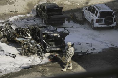 A U.S. soldier inspects the scene where  a parked car bomb exploded in a bustling section of downtown Baghdad early Wednesday.  (Associated Press / The Spokesman-Review)