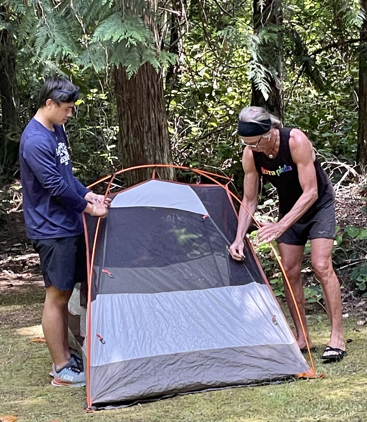 Zane Barnwell helps John put up an REI tent during a visit to Spencer Spit State Park. (Leslie Kelly)