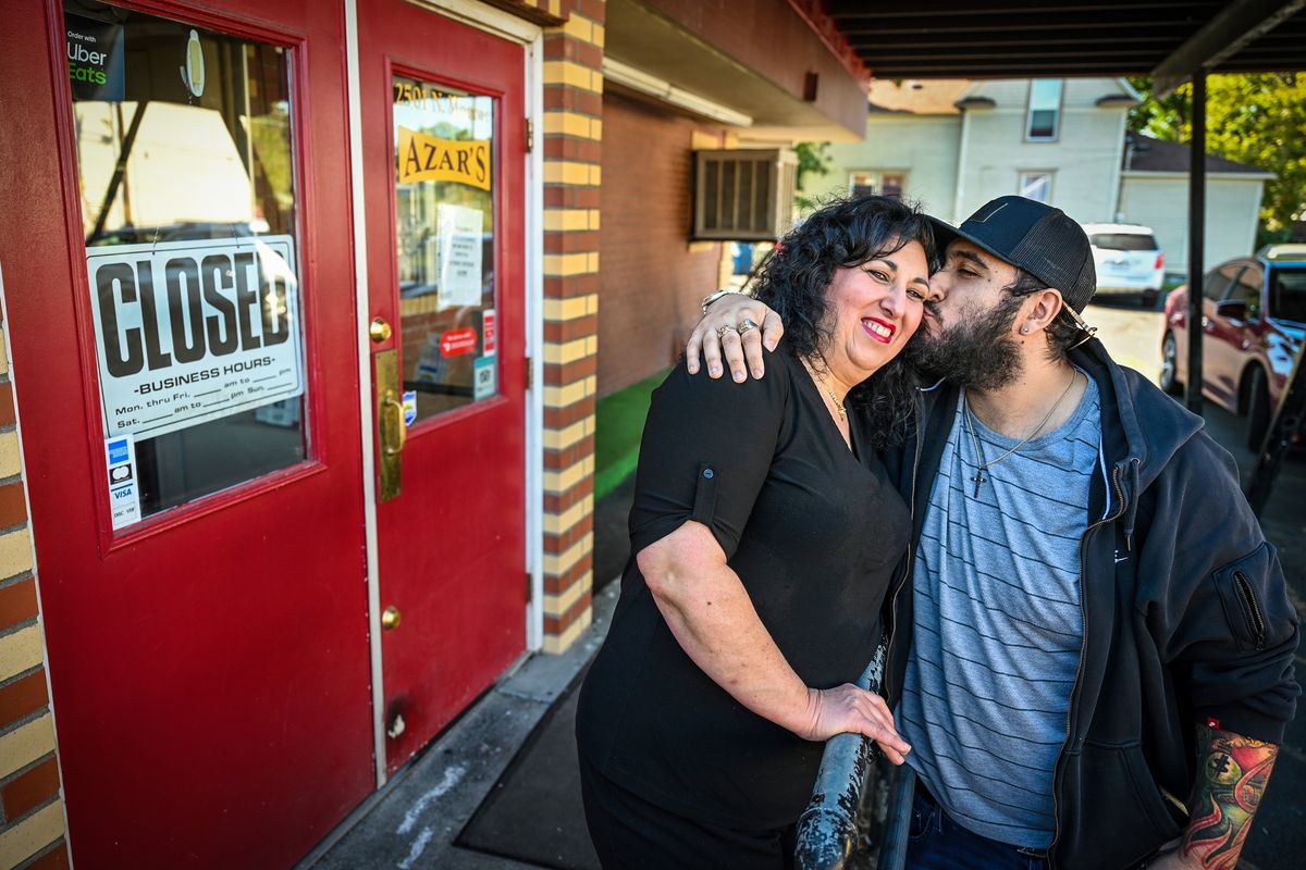 Katy Azar gets a hug and kiss from her son, Ramsey Azar, after family and friends gathered at Azars Restaurant on Tuesday to discuss the business closing. The Greek and Middle Eastern eatery has been in Spokane for 42 years, 32 years at 2501 N. Monroe.  (DAN PELLE/THE SPOKESMAN-REVIEW)
