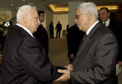 
 Israeli Prime Minister Ariel Sharon, left, and Palestinian Authority President Mahmoud Abbas shake hands Tuesday. 
 (Associated Press / The Spokesman-Review)