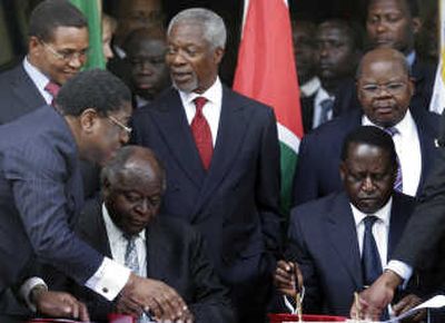 
Kenyan President Mwai Kibaki, center left, and opposition leader Raila Odinga, center right, sign a power-sharing deal Thursday in Nairobi, Kenya. Associated Press
 (Associated Press / The Spokesman-Review)