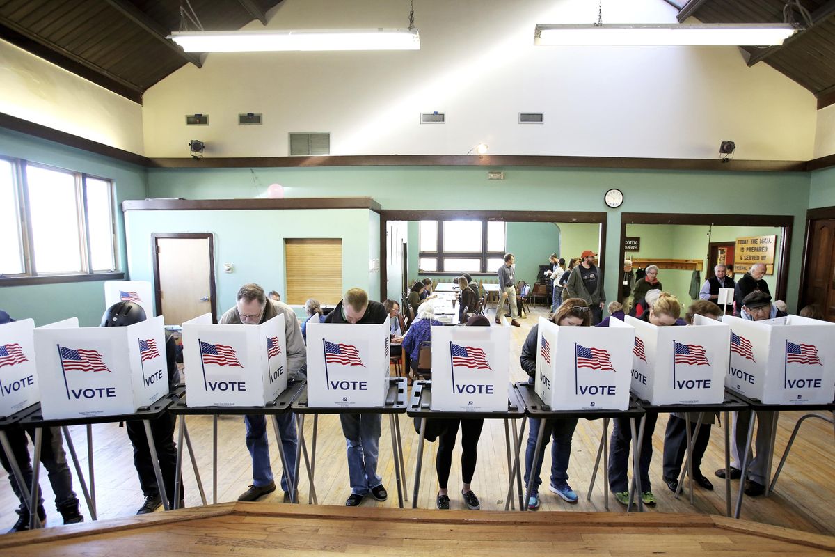 In this Tuesday, Nov. 8, 2016, file photo, voters cast their ballots at the Wil-Mar Neighborhood Center on the Near East Side of Madison, Wis. (Amber Arnold / Wisconsin State Journal via AP)