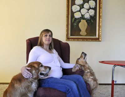 Michelle Casey, pictured with dogs Bacchus and Cassie, is expecting a daughter to be born in December. An ultrasound revealed the child has a bilateral cleft lip and palate. (Dan Pelle)