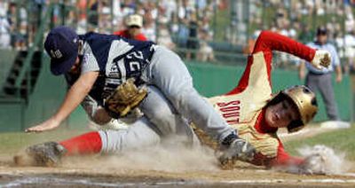
Texas' Zane Ancell, left, tags out Georgia's Keaton Allen at home. Associated Press
 (Associated Press / The Spokesman-Review)