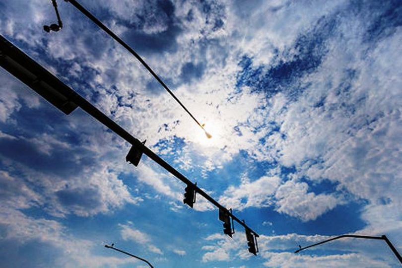 Two types of traffic cameras are used in controlled intersections by Idaho Transportation Department. One type is a non-recording, live-streaming camera, upper left. The other scans for vehicles to keep signals lights changing according to traffic conditions. (Shawn Gust / Coeur d'Alene Press)