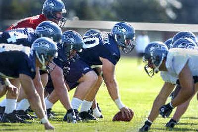 
Former Cougar Joey Hollenbeck sets to snap the ball during morning practice in Cheney at Seahawk training camp. 
 (Christopher Anderson/ / The Spokesman-Review)