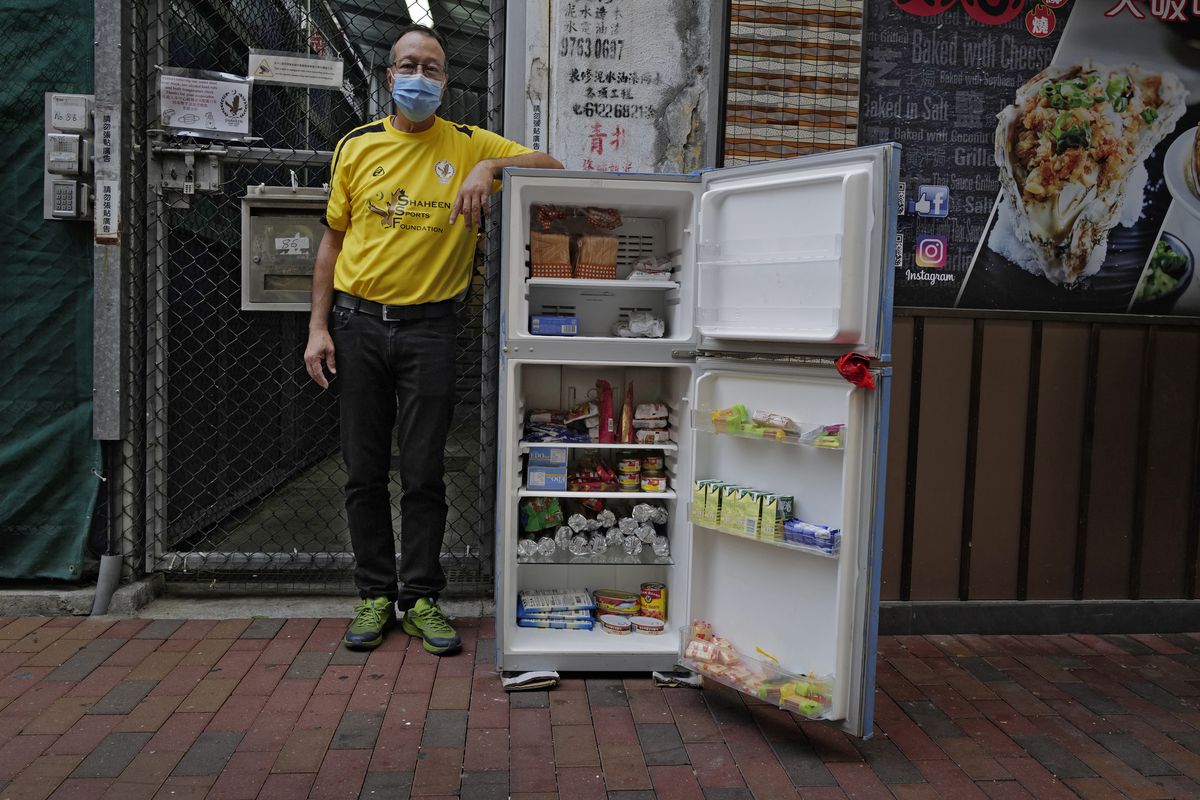Ahmed Khan poses with a refrigerator at Woosung Street in Hong Kong