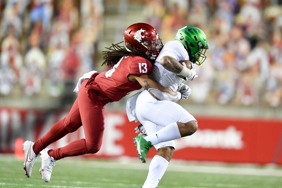 Washington State linebacker Jahad Woods (13) brings down Oregon Ducks running back CJ Verdell (7) during the second half of a college football game on Saturday, November 14, 2020, at Martin Stadium in Pullman, Wash.  (Tyler Tjomsland/THE SPOKESMAN-RE)