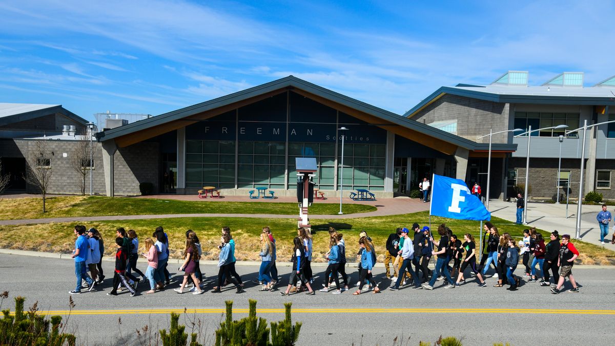 Freeman High School students march from their school to the football field to participate in a nation-wide walkout to protest gun violence, Friday, April 20, 2018. (Dan Pelle / The Spokesman-Review)