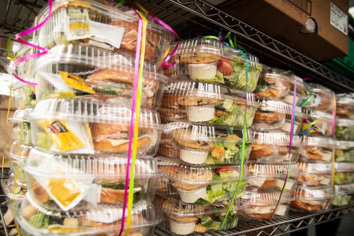 Prepackaged meals are seen during a distribution for the Extend the Love project outside of the Women & Children’s Free Restaurant & Community Kitchen on Tuesday, Jan. 19, 2021. The project is funded from local donors such as Washington Trust Bank, LifeWise and Visit Spokane and Spokane County, then $1,000 are disbursed to each participating local food venues such as O