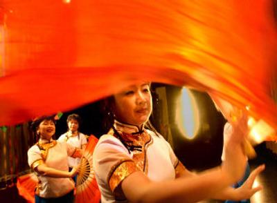 
Yan Meng practices the jasmine dance she and her fellow dancers performed at the opening of the Chinese New Year celebration at Spokane Community College. The day's events honored the Year of the Dog, with activities that included a culture fair and marketplace Saturday afternoon. 
 (Amanda Smith / The Spokesman-Review)