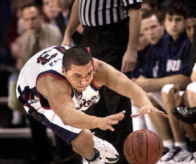 
Gonzaga center J.P Batista dives for a loose ball in the first half on Saturday. 
 (Brian Plonka / The Spokesman-Review)