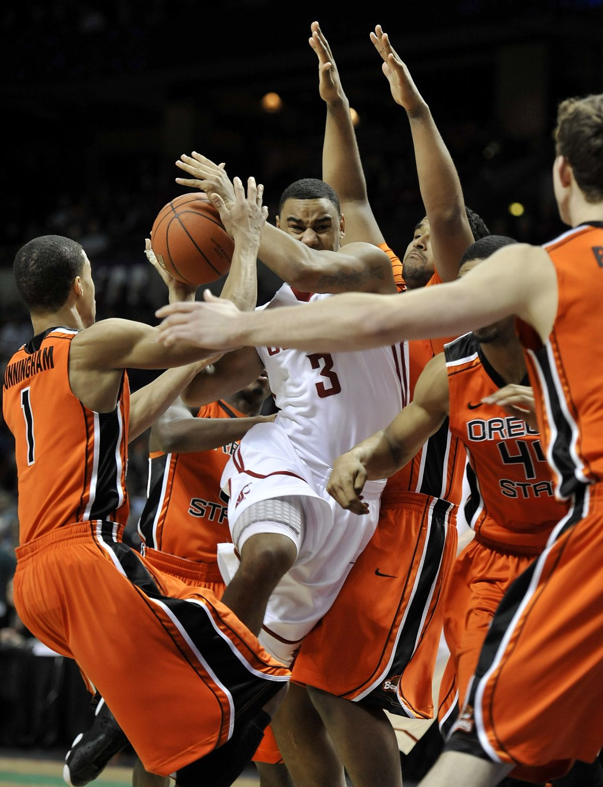 WSU’s DaVonte Lacy is surrounded by a colony of Beavers during first-half action at the Arena on Saturday. (Dan Pelle)