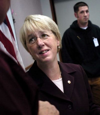 
Democratic Sen. Patty Murray reacts to a comment after a discussion about economic challenges faced by military service members Monday morning, while Air Force veteran Robby White, right, waits to have his photograph taken with the senator. 
 (Holly Pickett / The Spokesman-Review)