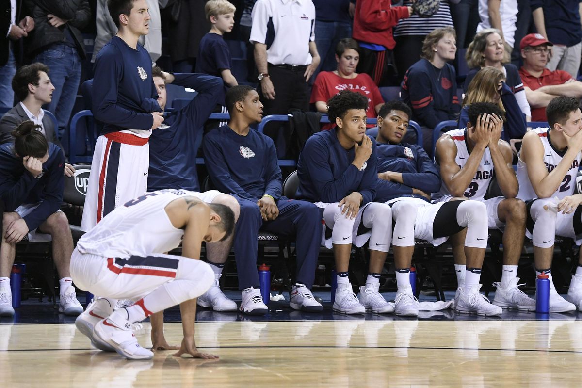 The Gonzaga bench and guard Nigel Williams-Goss, left, on the court, feel the pain of their first loss in the finals seconds against BYU, Feb. 25, 2017, in the McCarthey Athletic Center. (Dan Pelle / The Spokesman-Review)